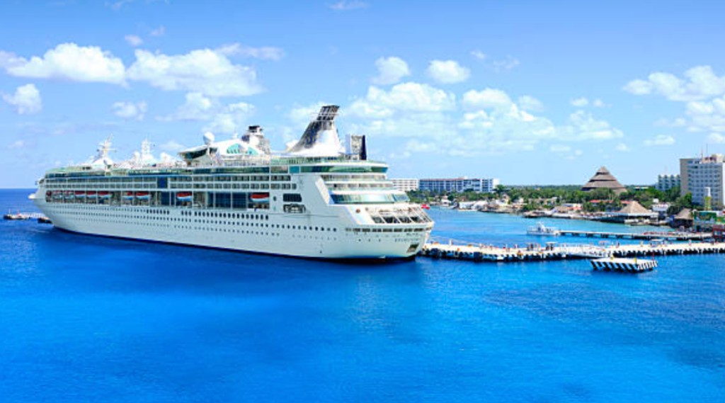 Royal Caribbean cruise ship docked at Cozumel Mexico cruise port pier with turquoise Caribbean water and tropical shoreline for cruise passengers