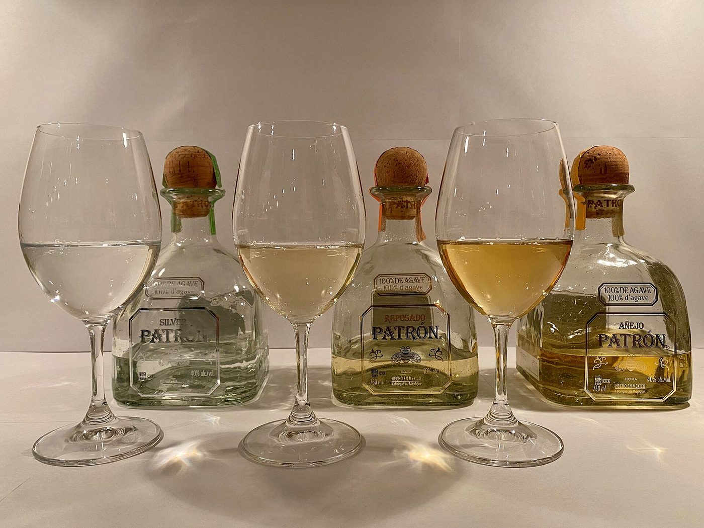 Silver, reposado and añejo tequila bottles with tasting glasses — representative tasting imagery for cultural shore excursions